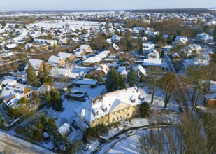 Residential area in winter with snow-covered classic buildings and trees, aerial view,