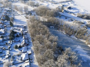 Snowy landscape with a frozen pond, trees and adjacent houses, aerial view, Oelsburg, Ilsede, Peine
