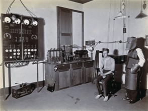 X-ray, hospital, man wearing a heavy apron, face mask and gloves to protect against X-rays,