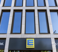 Yellow-blue Edeka company logo on a new building on Invalidenstraße in Mitte, Berlin, Germany