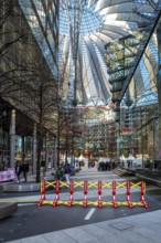 Massive metal access barriers in red and yellow at Center Potsdamer Platz, Berlin, Germany