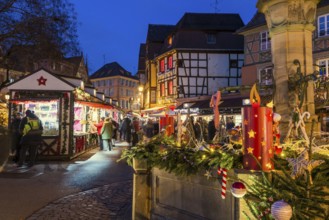 Colourfully illuminated and Christmassy decorated half-timbered houses, old town, blue hour,