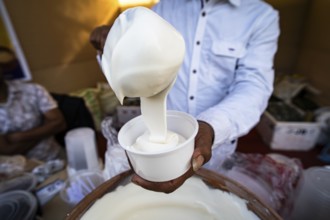 Vendor selling cream dairy product at a stall in Bhogali Mela, ahead of the 'Magh Bihu' festival,