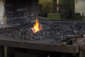 A blacksmith forging, working at the Ehnert forge in Dresden-Bühlau, Saxony, Germany