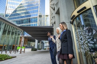 Diverse business colleagues walking and talking together, sharing ideas while navigating a modern