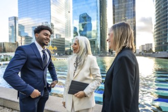 Diverse business professionals having a dynamic informal meeting and discussing ideas outdoors in a