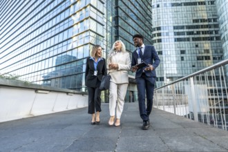 Three diverse business professionals. Including a young black man. A mature woman. And a young