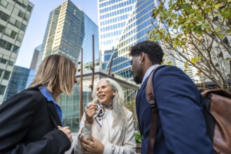 Diverse group of business people collaborating and networking outside in a modern office district,
