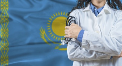 Healthcare professional with Kazakhstan flag background. Professional doctor holding stethoscope on