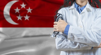 Healthcare professional with Singapore flag background. Professional doctor holding stethoscope on