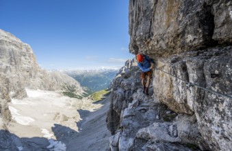 Mountaineers on a narrow band of rocks on the Via Ferrata Bocciere Centrale via ferrata,