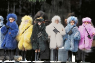 Barbie dolls in different colored fur coats in a shop window, New York City, USA
