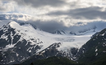 Mountain peak with Worthington Glacier glacier, dramatic cloudy sky, picturesque landscape on