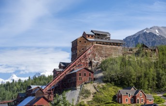 Red Kennicott buildings in front of mountainous landscape, Kennicott Concentration Mill to extract