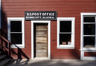Red Kennicott buildings against mountainous landscape, Kennecott Post Office, Historic Kennecott