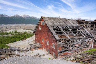 Red dilapidated buildings of Kennicott against mountainous landscape, Historic Kennecott Copper
