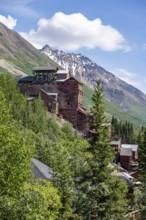 Red Kennicott buildings in front of mountainous landscape, Kennicott Concentration Mill to extract