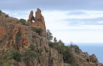 Heart shaped hole, bizarre rock erosions in the evening light, Calanche, Les Calanches de Piana,