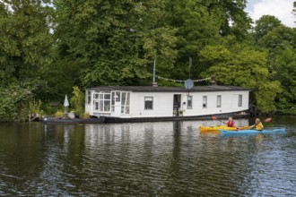 Houseboat on the Hunte with canoeists, Oldenburg, Lower Saxony, Germany