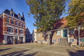 Historic town hall, city museum, historic brick building, houses, façade with windows, stairway,