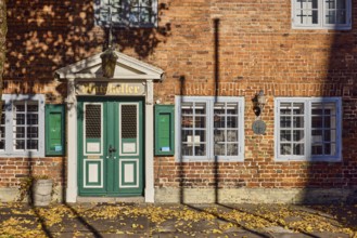Historic Ratskeller restaurant, brick building, entrance, façade with windows and lamp, fallen