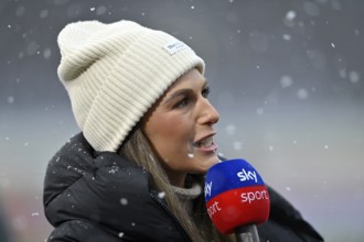 SKY reporter presenter Mara Mones wears hat in interview microphone micro logo portrait snow, snow
