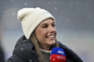 SKY reporter presenter Mara Mones wears hat in interview microphone micro logo portrait smiling,