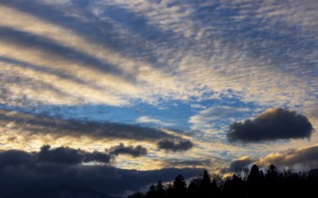 Dramatic cloudy sky, cirrus clouds at sunset, plume clouds, Austria