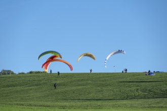 Paragliders practice on a meadow slope, Tauchersreuth, Middle Franconia, Bavaria, Germany