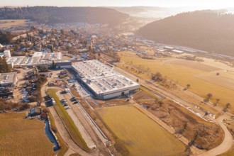 Factory building next to village and snow-covered fields, Glatten, Freudenstadt district, Germany