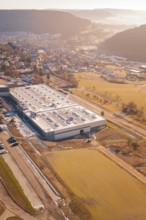 Factory near a village with fields in a wintry landscape, Glatten, Freudenstadt district, Germany