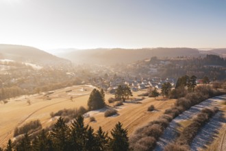 Wintery fields and a village illuminated by morning light, Glatten, Freudenstadt district, Germany