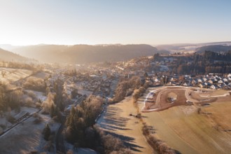 Extensive winter landscape with village and fields under clear sky, Glatten, Freudenstadt district,