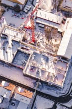 Detailed view of a snowy construction site with visible building materials, Zellerschule new