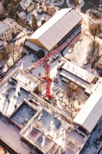 Detailed aerial view of a construction site in a snowy urban landscape, Zellerschule building,
