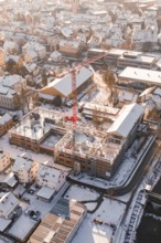 Close view of a snowy construction site in the middle of an urban residential area, Zellerschule