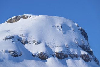 Snowy mountain with steep rocks under clear sky, Gemmi Pass, Leukerbad, Leuk, Valais, Switzerland
