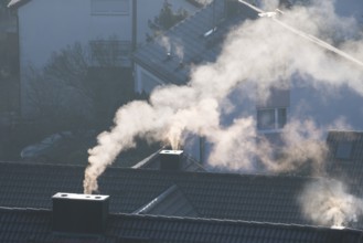 Close-up of a chimney from which smoke rises in a quiet morning mood, symbolic picture, fireplaces,