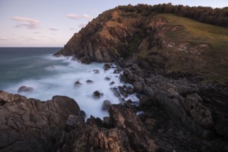 Sunset, Byron Bay, New South Wales, Australia. Waves crashing on rocks at the most easterly point