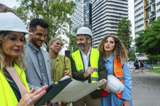 Group of diverse architects, engineers, and real estate professionals collaborating on a building