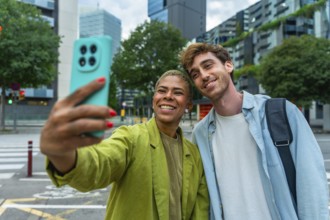 Diverse couple smiling and taking a selfie with a smartphone, sharing a moment of connection and