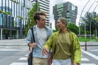 Engaging diverse colleagues walking across a city crosswalk, sharing a moment of laughter while