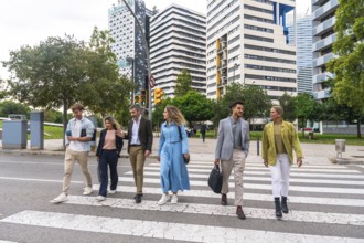 Diverse group of smiling business professionals walking together on a zebra crossing in a modern