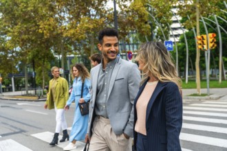 Group of executives and colleagues communicating while crossing a busy urban street, representing