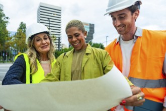 Diverse team of architects and construction professionals collaborating and discussing building