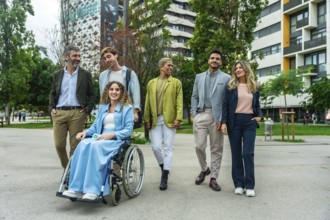 Diverse group of colleagues and executives including a woman in a wheelchair walking and discussing