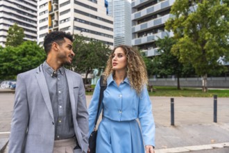 Business colleagues having a discussion while walking through a contemporary urban area, presenting