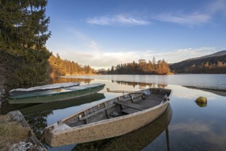 Wooden rowing boats on wintry Reintaler See, Reintaler See, Tyrol, Austria