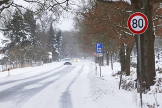 Road traffic in winter, icy road covered with snow with car traffic, risk of accident,