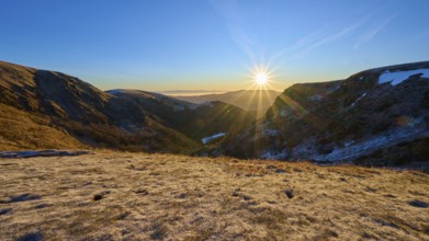 Frosty mountain landscape at sunrise with bright sunlight and clear sky, winter, Route de Cretes,